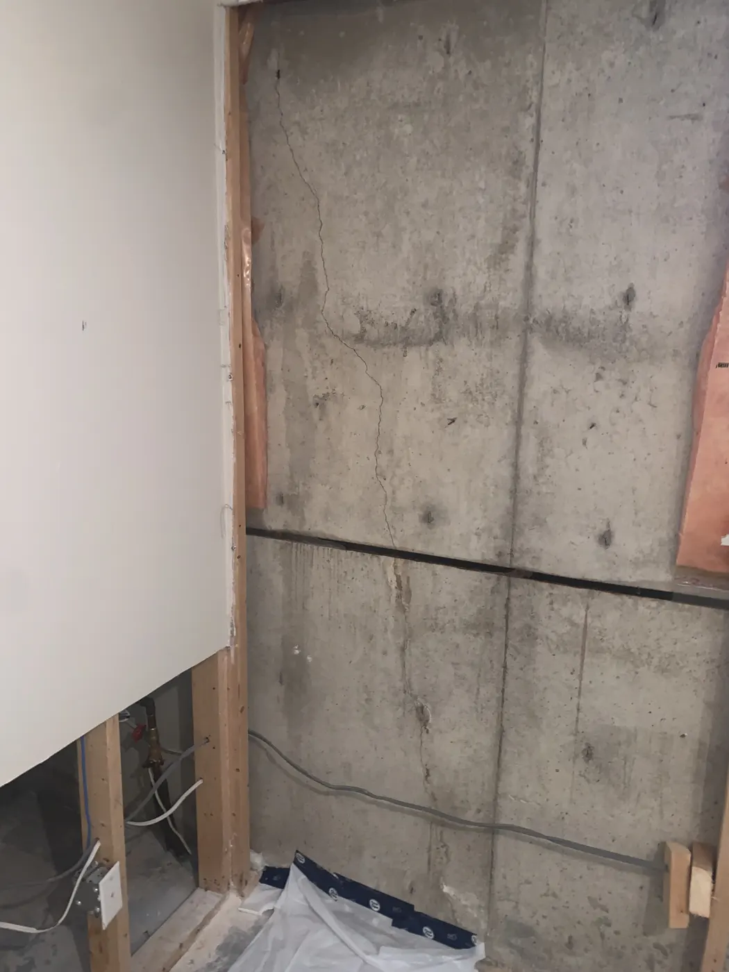Polyurethane foam sealing a diagonal foundation crack from window corner to floor during injection