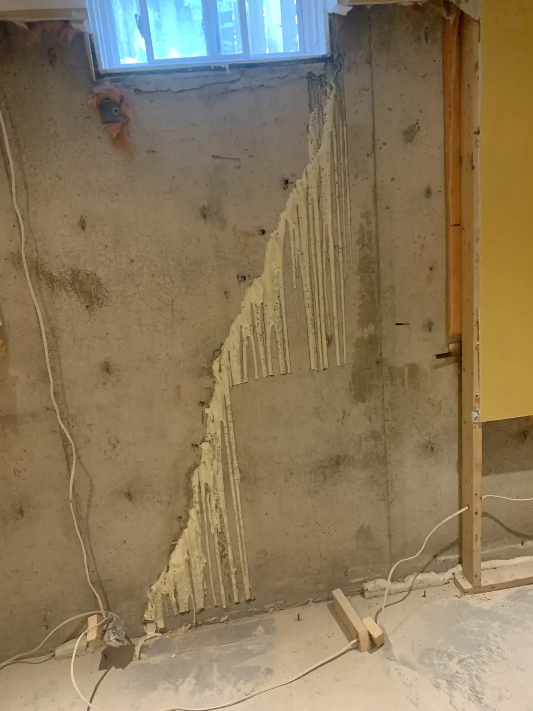 Cured polyurethane foam along a full-height injected foundation crack before trimming and patching